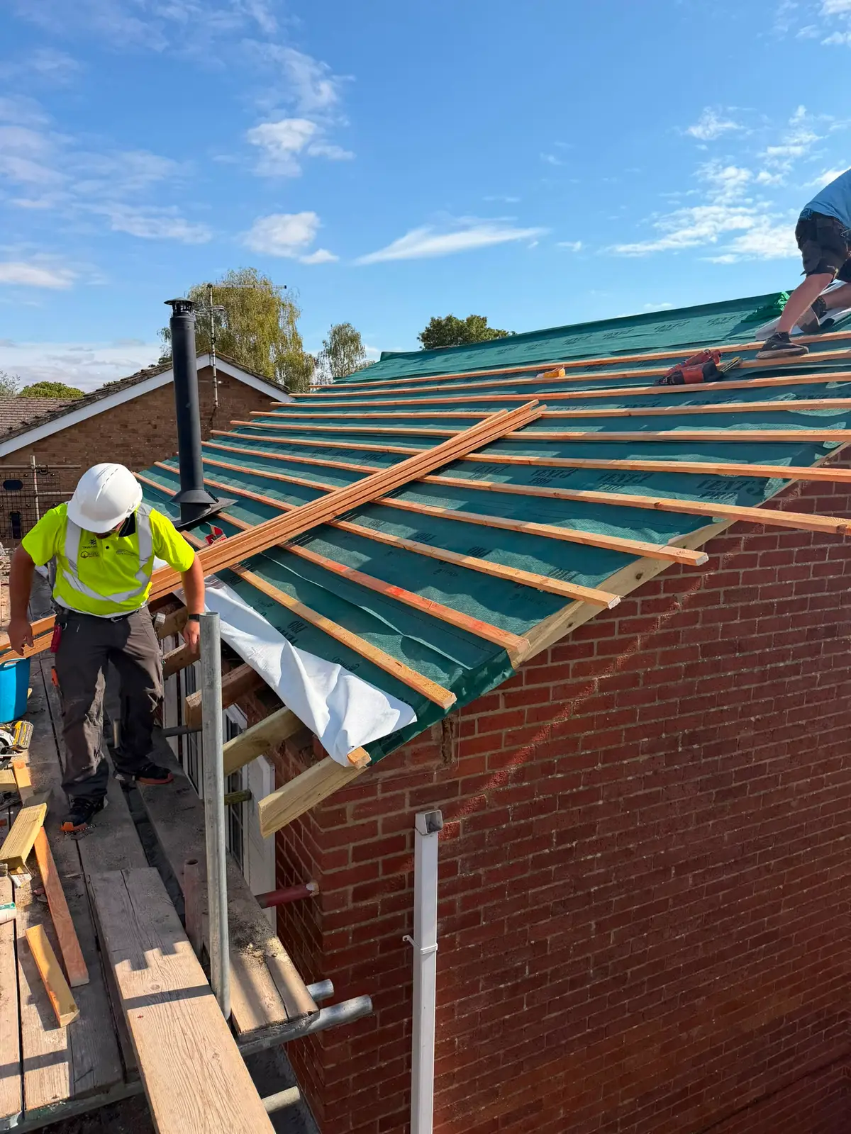 Vanguard roofers fitting battens over breathable membrane on a new roof in Newbury