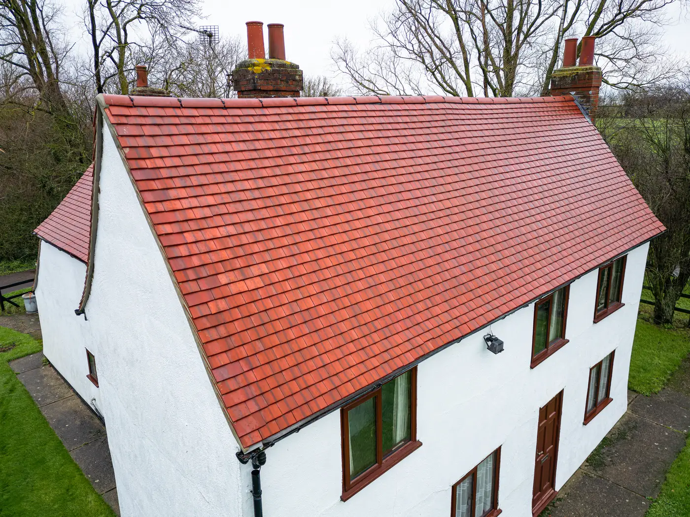 Aerial view of a restored red clay tile roof on a period cottage in Devizes