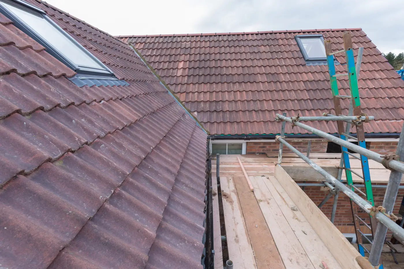 Newly tiled roof with rooflight windows and scaffolding during a renovation in Devizes