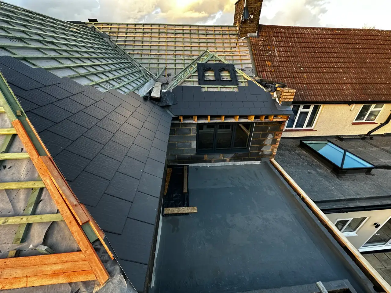 Aerial view of a new slate roof and rear dormer being installed on a house extension in Andover
