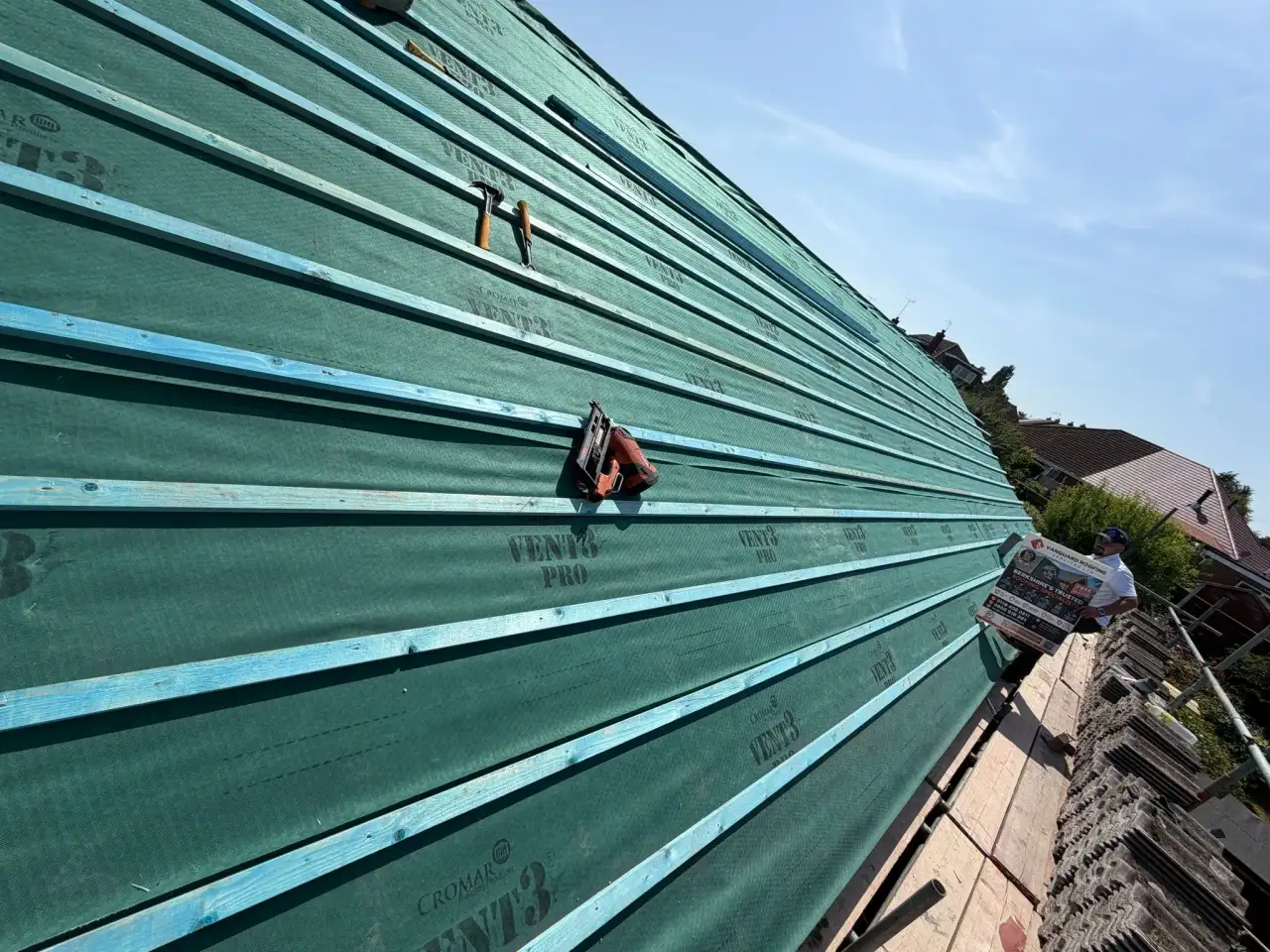 Vanguard Roofing Services Ltd site board displayed on a newly battened roof deck during a re-roof in Andover