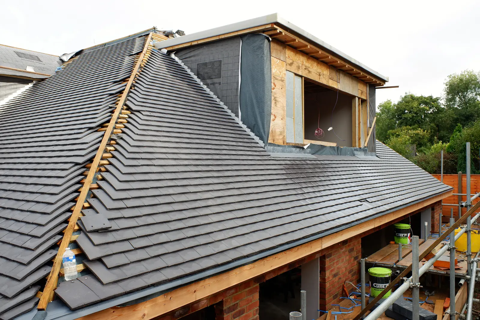 Grey concrete tile roof with a new dormer extension under construction in Bath